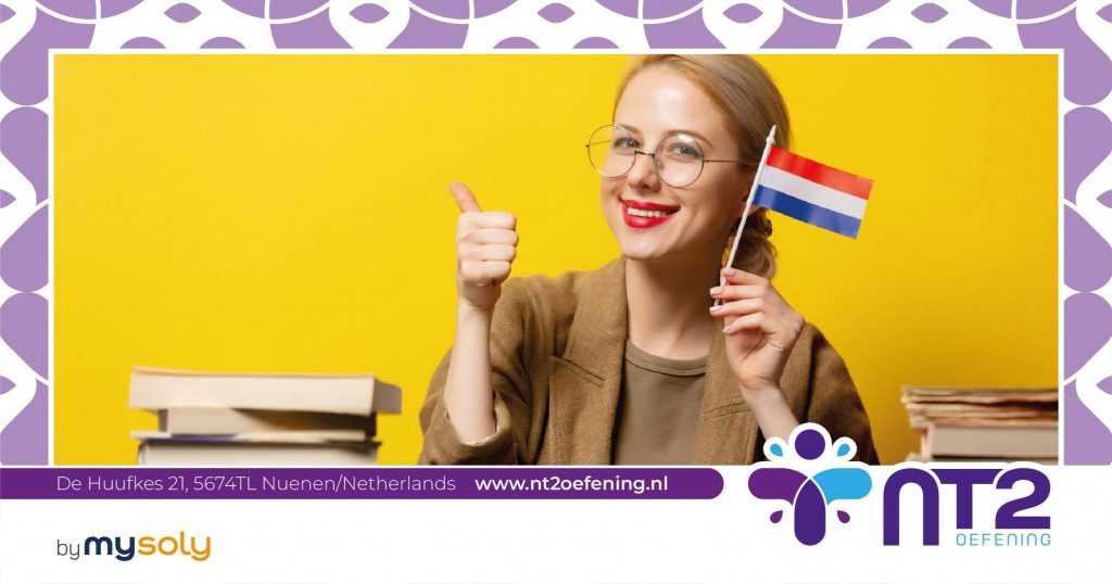 A woman holding a Dutch flag sitting behind a desk with language books