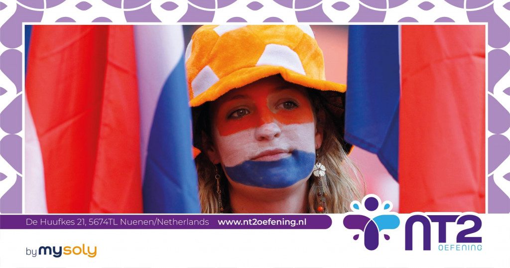 A woman with her face painted in the colors of the Dutch flag, holding Dutch flags