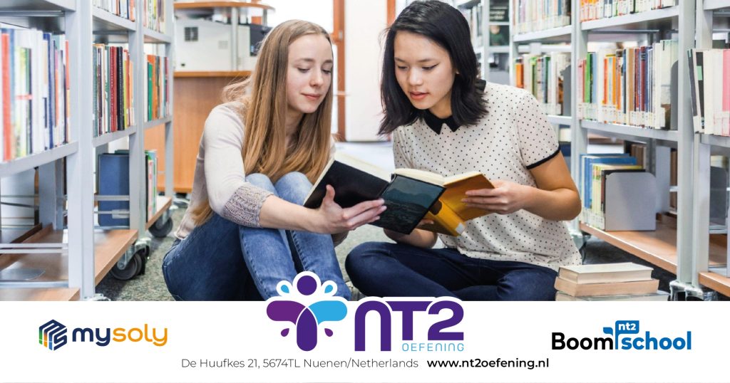 two young women reading books in Dutch in the library.
